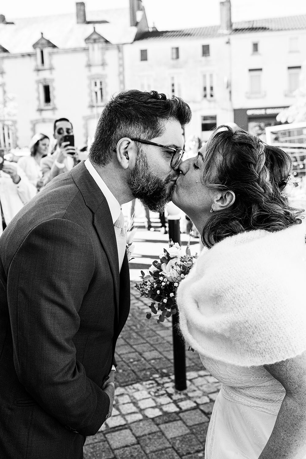 couple qui s'embrasse devant la mairie, pris en photo par Loïc Pierrois, photographe de mariage à Angers